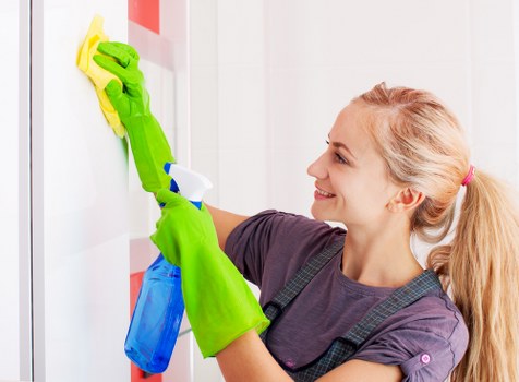 Cleaning staff handling waste in line with regulations